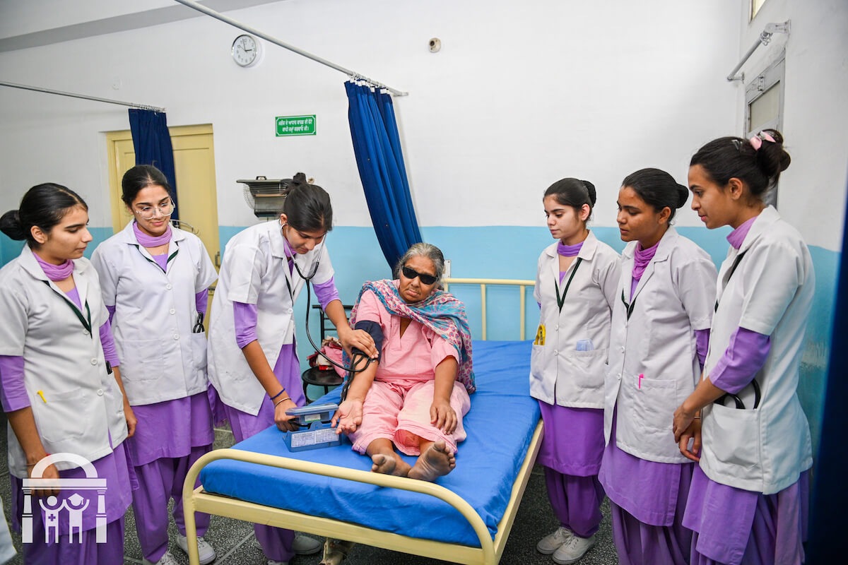 Guru Nanak College of Nursing students in clinical practice with patient in Dhahan Kaleran